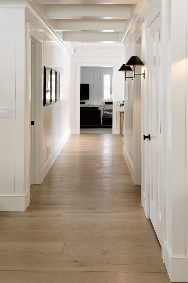 Foto di un grande ingresso o corridoio scandinavo con pareti bianche, pavimento in legno massello medio, pavimento marrone, soffitto a cassettoni e pareti in perlinato