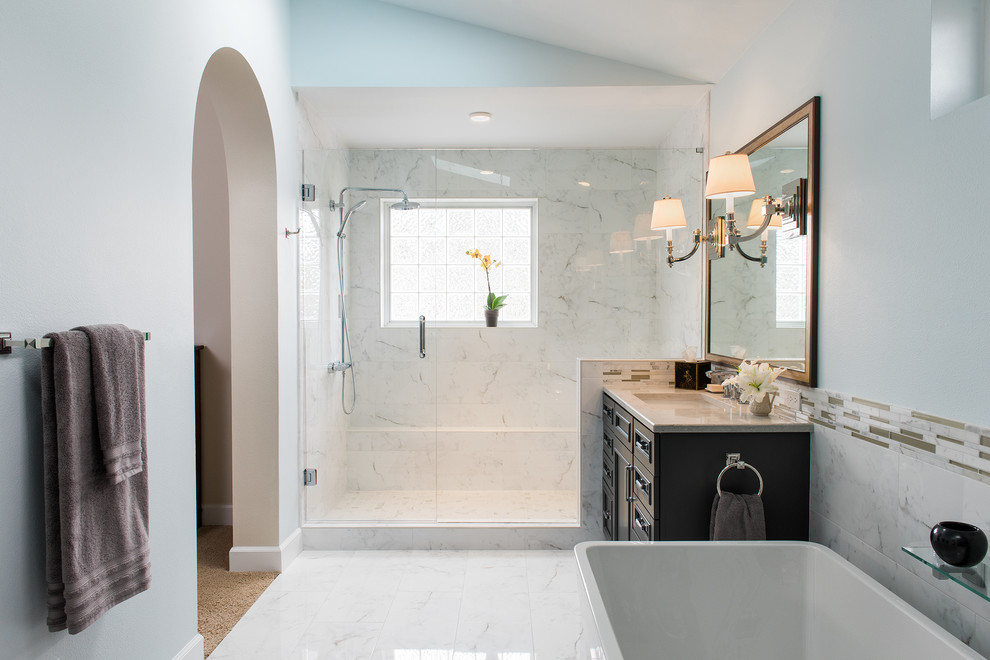 Inspiration for a mid-sized modern master bathroom in Other with beaded inset cabinets, black cabinets, a freestanding tub, an alcove shower, beige tile, black and white tile, matchstick tile, white walls, marble floors, an undermount sink and solid surface benchtops.