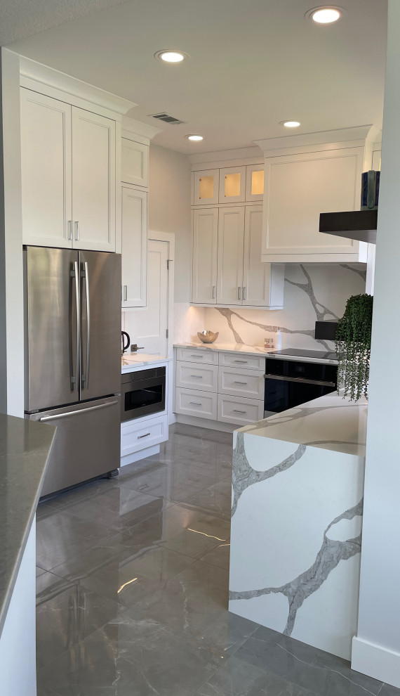 This is an example of a medium sized traditional galley kitchen pantry in Miami with a submerged sink, flat-panel cabinets, white cabinets, engineered stone countertops, white splashback, engineered quartz splashback, white appliances, porcelain flooring, no island, grey floors and white worktops.