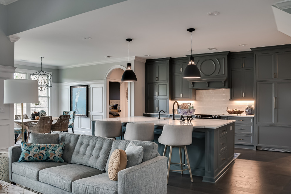 Transitional dark wood floor eat-in kitchen photo with an undermount sink, flat-panel cabinets, gray cabinets, quartz countertops, white backsplash, subway tile backsplash, paneled appliances, an island and white countertops