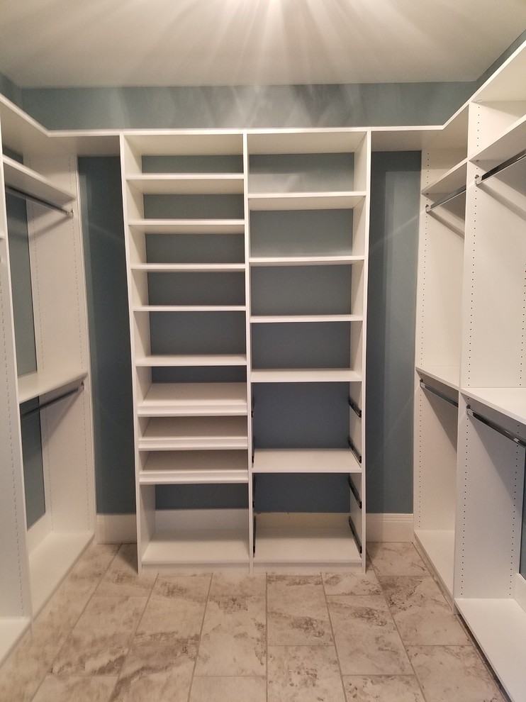 Design ideas for a mid-sized transitional gender-neutral walk-in wardrobe in Louisville with open cabinets, white cabinets, porcelain floors and brown floor.