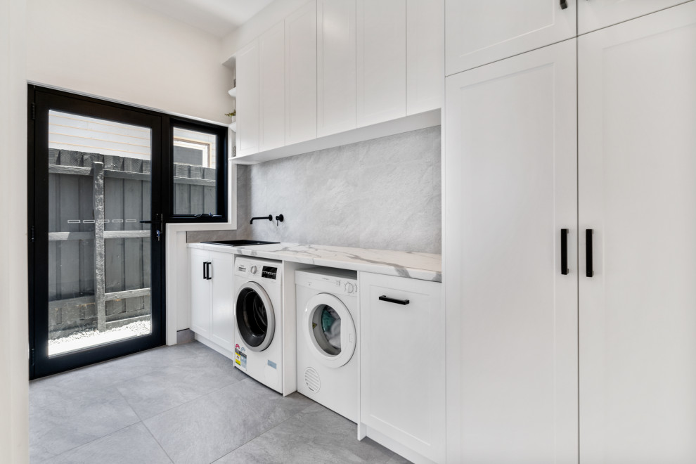 This is an example of a beach style laundry room in Melbourne.