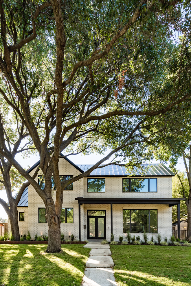 Inspiration for a large transitional two-storey white house exterior in Dallas with concrete fiberboard siding, a gable roof and a metal roof.