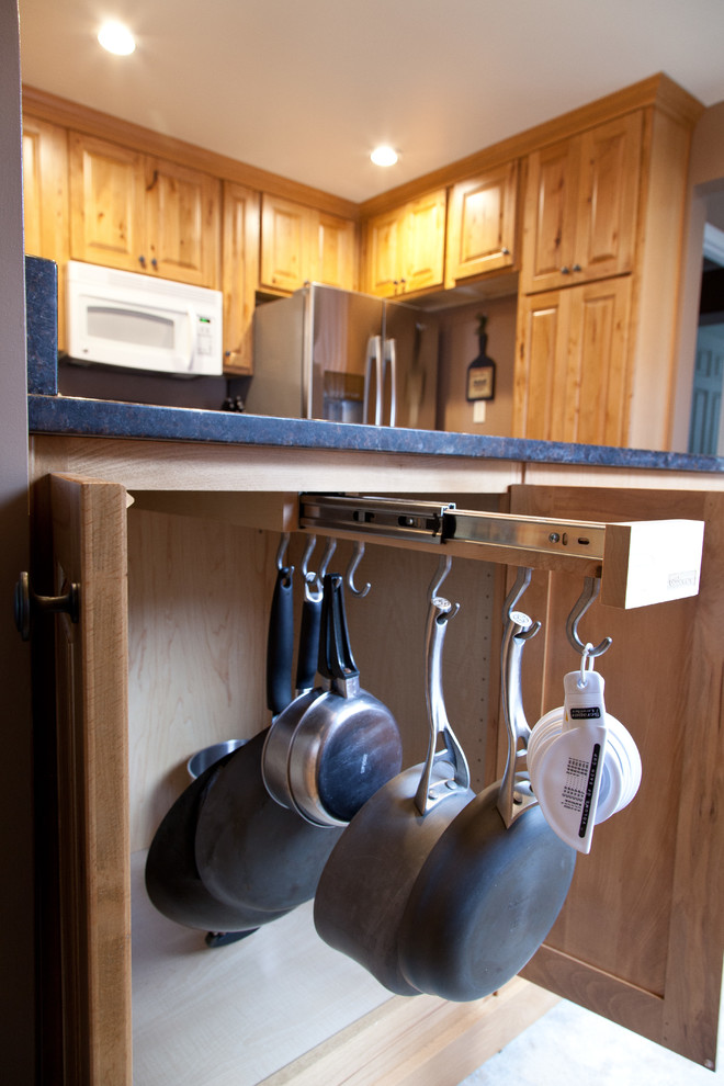 Example of a small classic u-shaped kitchen design in Other with an undermount sink, raised-panel cabinets, light wood cabinets, granite countertops and stainless steel appliances