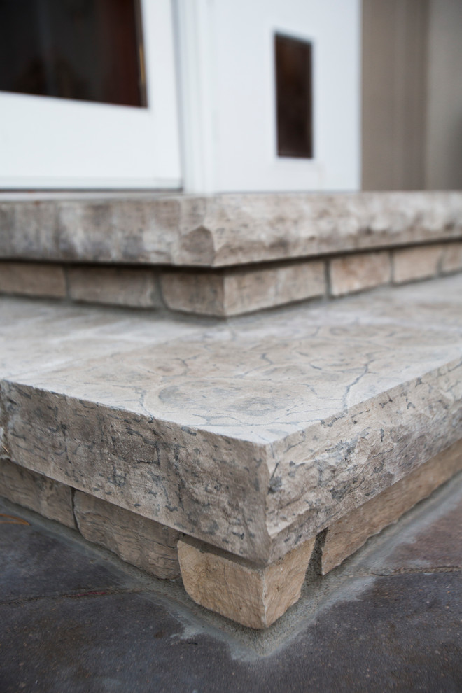 Photo of a transitional backyard stone water fountain landscape in Omaha.