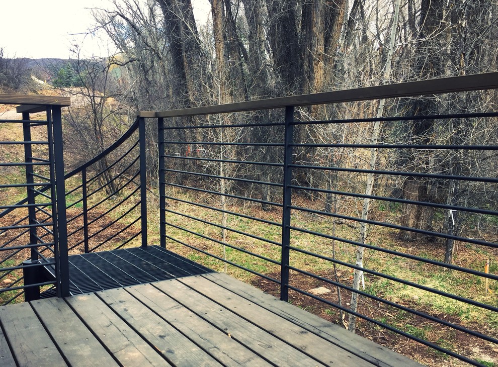 Example of a mid-sized mountain style backyard deck design in Denver with no cover