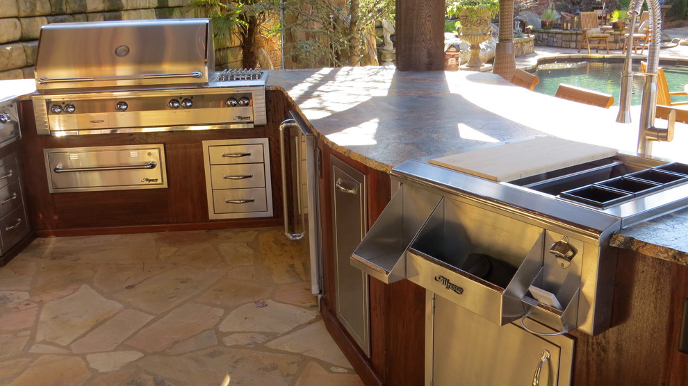 This is an example of a mid-sized tropical backyard patio in Other with an outdoor kitchen, concrete slab and no cover.