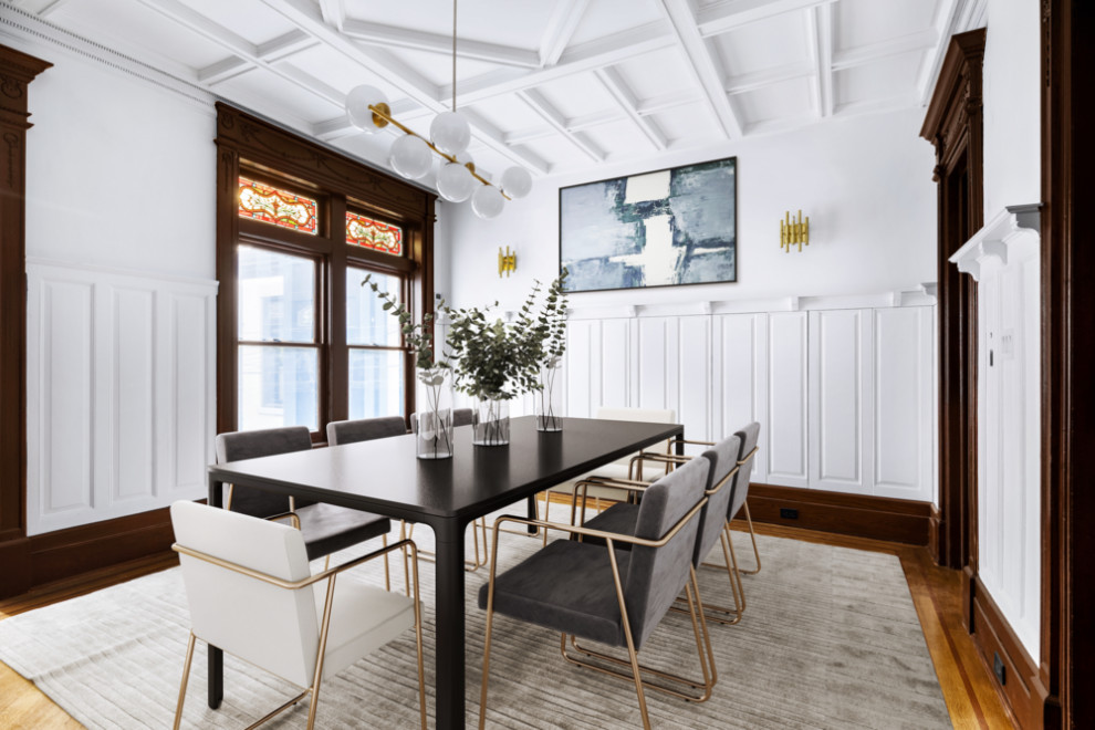 Inspiration for a large classic dining room in New York with white walls, light hardwood flooring, a standard fireplace, a wooden fireplace surround, beige floors, a coffered ceiling and tongue and groove walls.