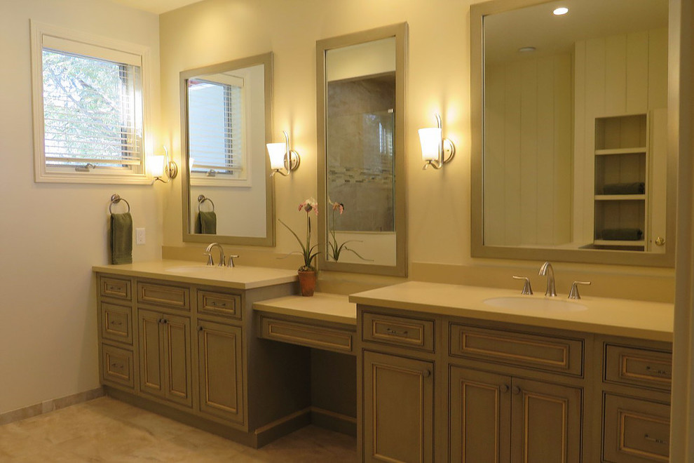 Mid-sized transitional master bathroom in Other with recessed-panel cabinets, green cabinets, a corner shower, beige walls, ceramic floors, an undermount sink and solid surface benchtops.