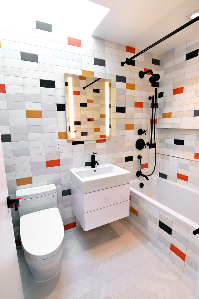 This is an example of a mid-sized modern kids bathroom in New York with flat-panel cabinets, white cabinets, a drop-in tub, a two-piece toilet, red tile, ceramic tile, white walls, marble floors, a pedestal sink, quartzite benchtops, beige floor and white benchtops.