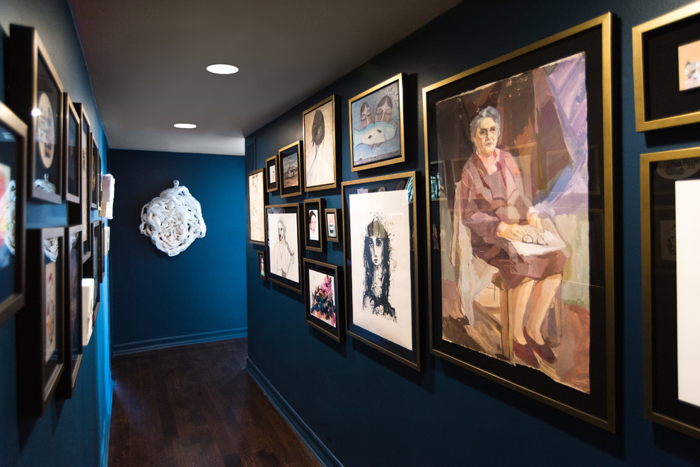 This is an example of a contemporary hallway in Los Angeles with blue walls, dark hardwood floors and blue floor.