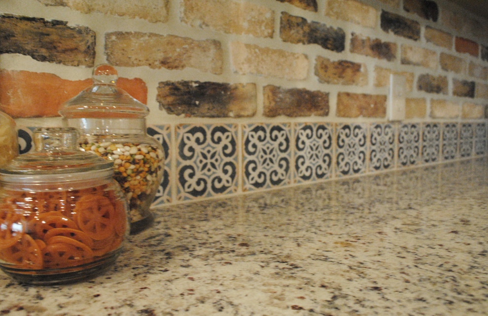 Mid-sized transitional l-shaped kitchen in Austin with a farmhouse sink, recessed-panel cabinets, beige cabinets, granite benchtops, cement tile splashback, stainless steel appliances, vinyl floors and with island.