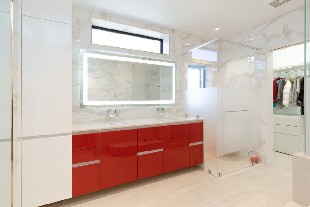 This is an example of a large master bathroom in San Francisco with flat-panel cabinets, red cabinets, a drop-in tub, an alcove shower, white tile, ceramic tile, white walls, an integrated sink, beige floor, a hinged shower door and white benchtops.