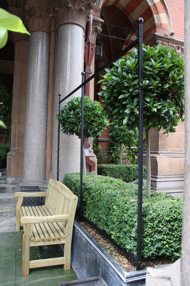 Photo of a small contemporary courtyard formal garden in London with with outdoor playset.