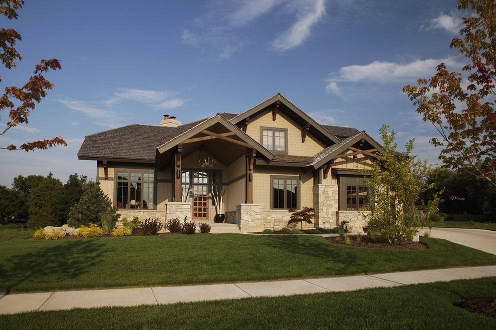 Design ideas for a large country two-storey beige exterior in Chicago with wood siding.