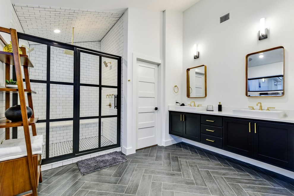 Photo of a modern master bathroom in Austin with shaker cabinets, black cabinets, a double shower, white tile, subway tile, white walls, a drop-in sink, grey floor, a hinged shower door and white benchtops.