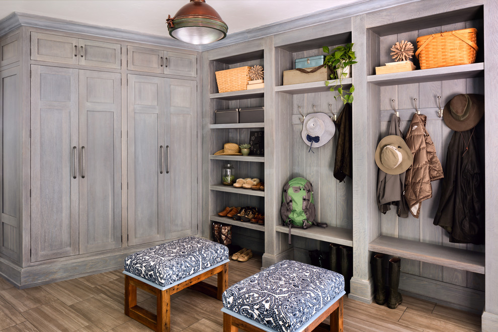 Inspiration for a large country mudroom in Milwaukee with grey walls.