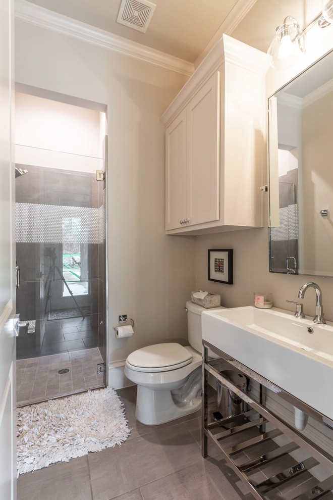 Design ideas for a large country kids bathroom in Dallas with raised-panel cabinets, white cabinets, an alcove shower, a one-piece toilet, gray tile, ceramic tile, beige walls, ceramic floors, a pedestal sink, beige floor and a hinged shower door.