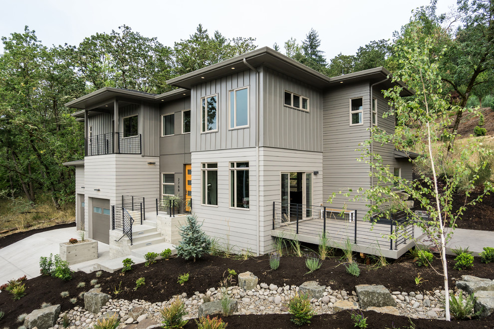This is an example of an expansive modern two-storey grey exterior in Other with mixed siding.