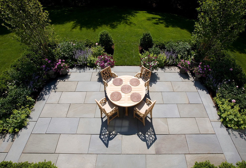 Photo of a traditional backyard garden in Boston with natural stone pavers.