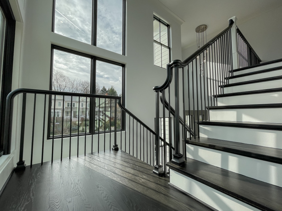 Large transitional wood floating staircase in DC Metro with wood risers, mixed railing and panelled walls.