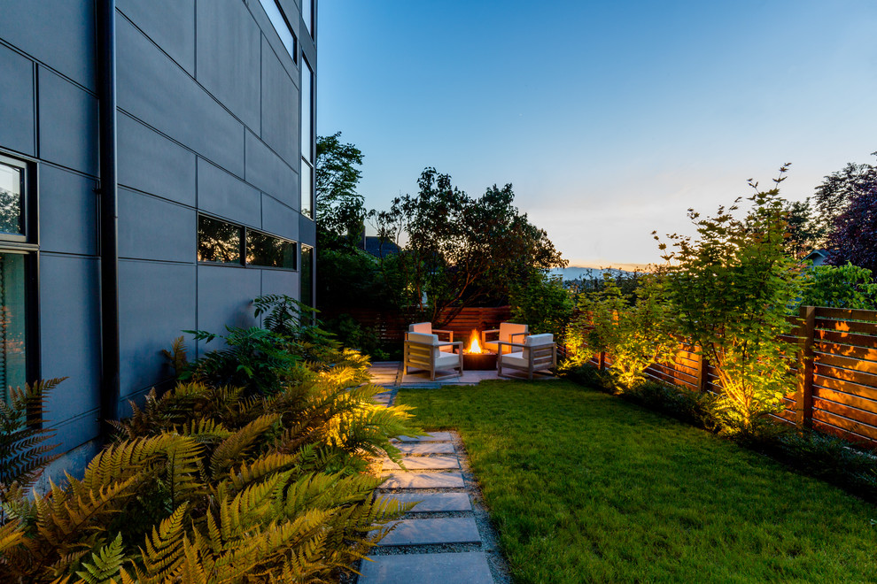 Photo of a small contemporary backyard partial sun garden in Seattle with a fire feature and concrete pavers.