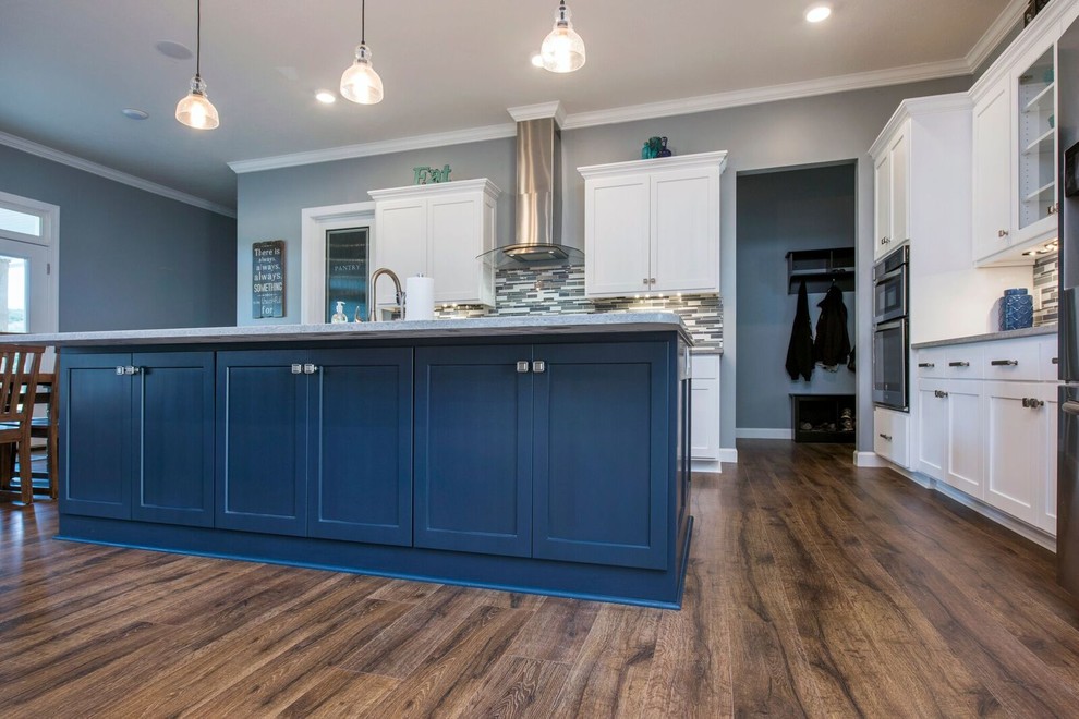 Enclosed kitchen - mid-sized transitional single-wall dark wood floor and brown floor enclosed kitchen idea in Columbus with a farmhouse sink, shaker cabinets, white cabinets, granite countertops, multicolored backsplash, matchstick tile backsplash, stainless steel appliances, an island and gray countertops