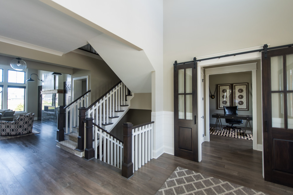 This is an example of a mid-sized contemporary hallway in Indianapolis with beige walls and dark hardwood floors.