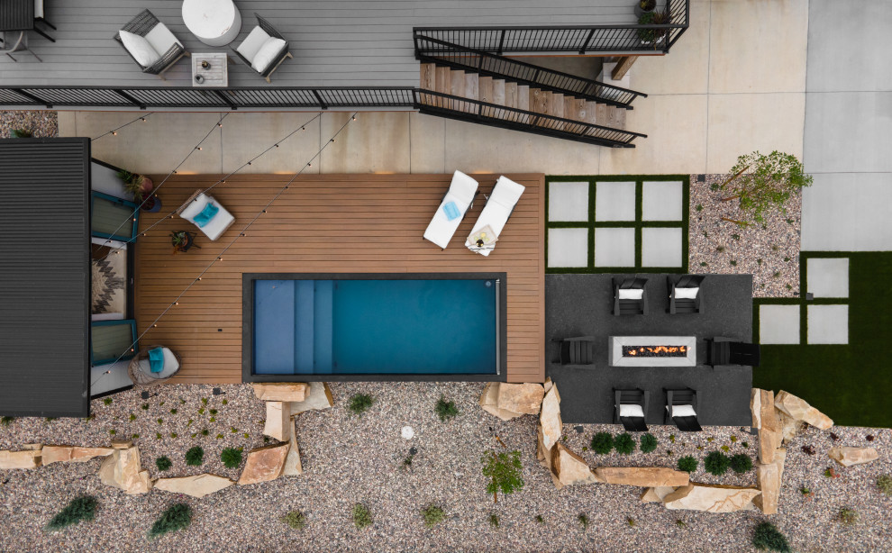 Design ideas for a mid-sized modern backyard partial sun garden with a fire feature and decking.