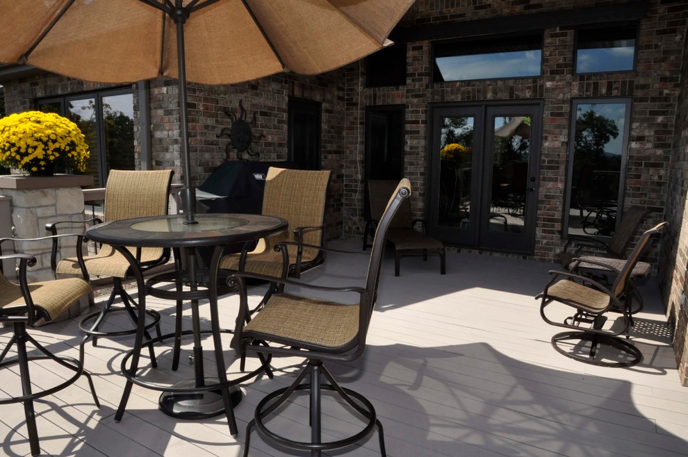 Example of a mid-sized classic backyard deck design with no cover
