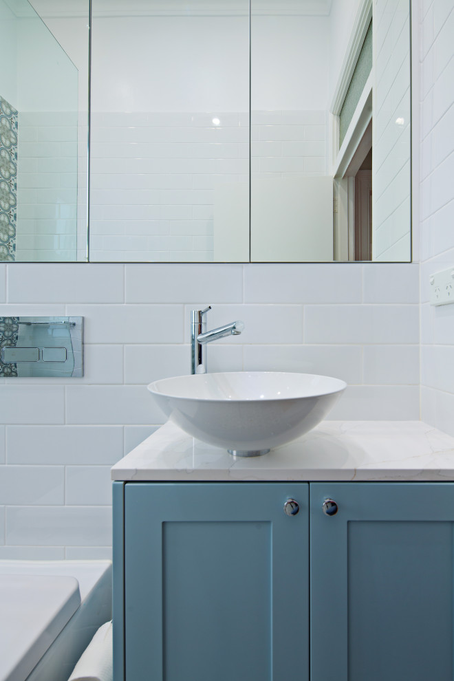 Design ideas for a small contemporary bathroom in Sydney with shaker cabinets, blue cabinets, an open shower, a one-piece toilet, white tile, ceramic tile, multi-coloured walls, ceramic floors, a drop-in sink, engineered quartz benchtops, multi-coloured floor, white benchtops, a single vanity and a freestanding vanity.
