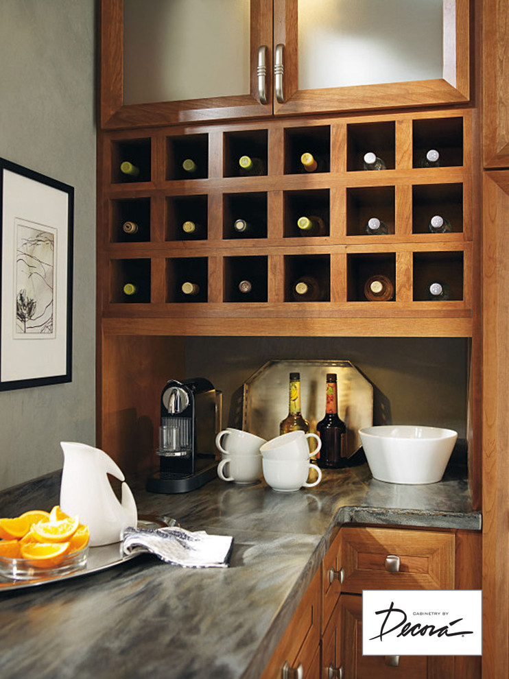 Eat-in kitchen - small l-shaped eat-in kitchen idea with medium tone wood cabinets, stainless steel appliances, a peninsula and gray countertops
