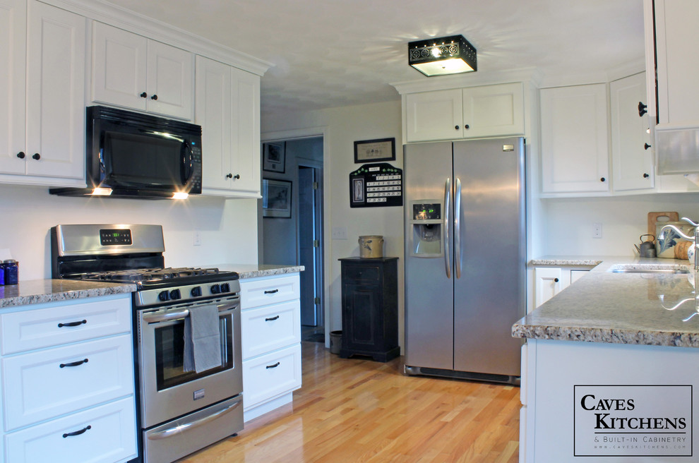 Inspiration for a small transitional u-shaped medium tone wood floor eat-in kitchen remodel in New York with an undermount sink, recessed-panel cabinets, white cabinets, granite countertops, white backsplash, stainless steel appliances and no island