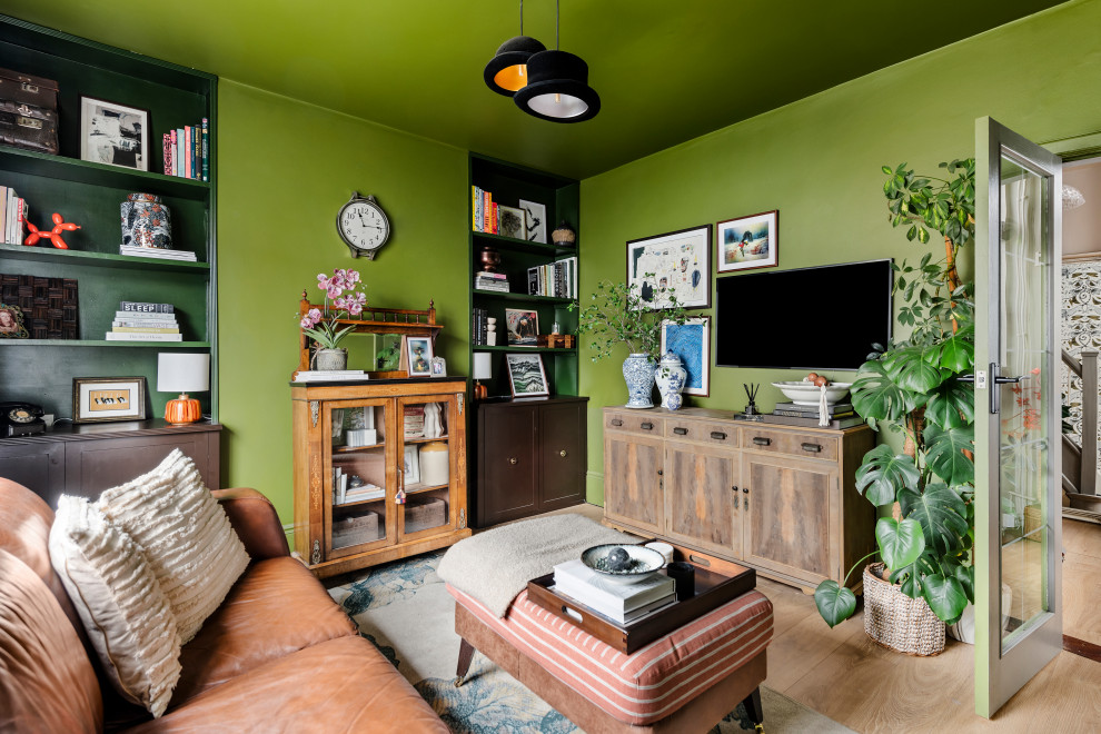 Eclectic enclosed games room in Other with green walls, light hardwood flooring and a wall mounted tv.