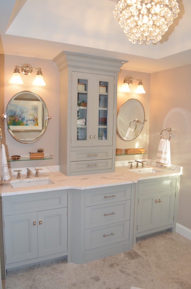 Example of a mid-sized transitional master beige tile and stone tile limestone floor freestanding bathtub design in Boston with an undermount sink, recessed-panel cabinets, blue cabinets, limestone countertops, a one-piece toilet and beige walls