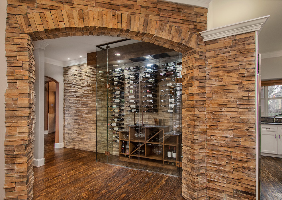 Mid-sized country wine cellar in Dallas with medium hardwood floors, display racks and brown floor.