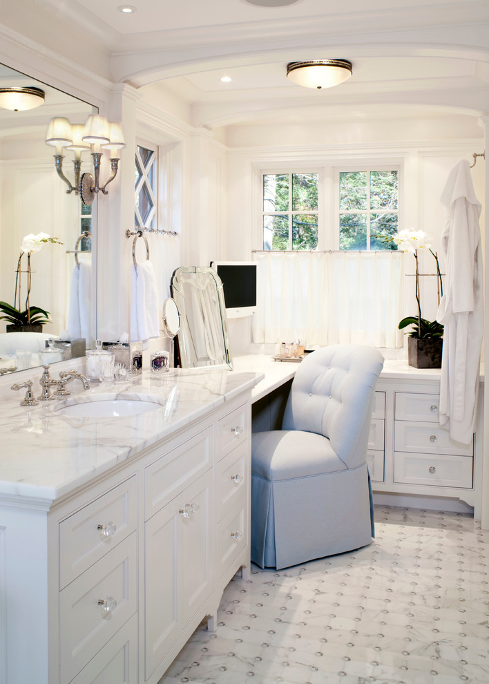 This is an example of a contemporary bathroom in Boston with an undermount sink, marble benchtops, a freestanding tub, beaded inset cabinets, white cabinets, mosaic tile, white tile, white walls and marble floors.