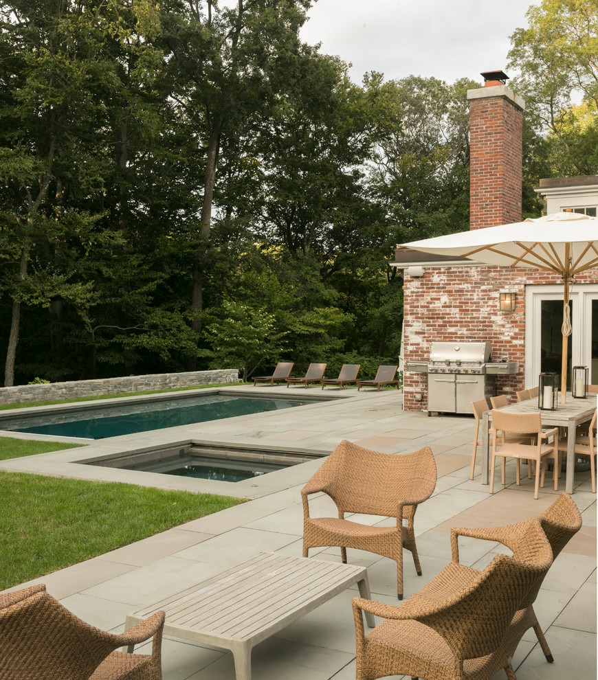 Inspiration for a contemporary pool in Boston with natural stone pavers.
