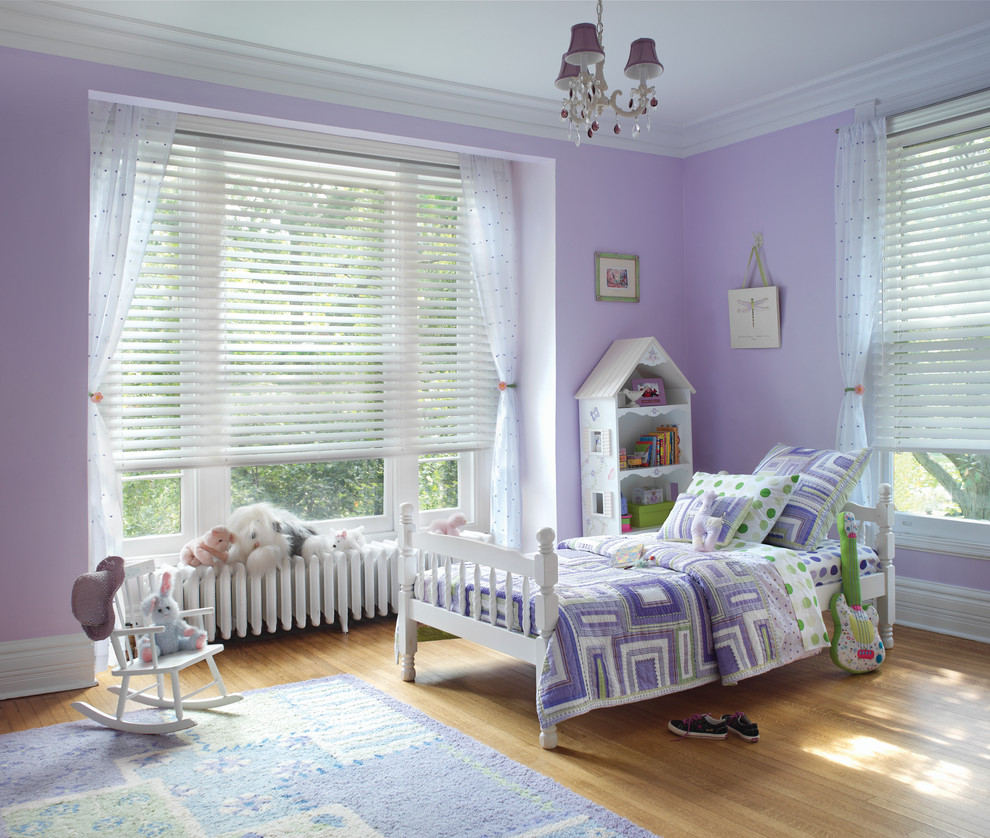 Kids' room - mid-sized traditional girl medium tone wood floor and brown floor kids' room idea in Edmonton with purple walls
