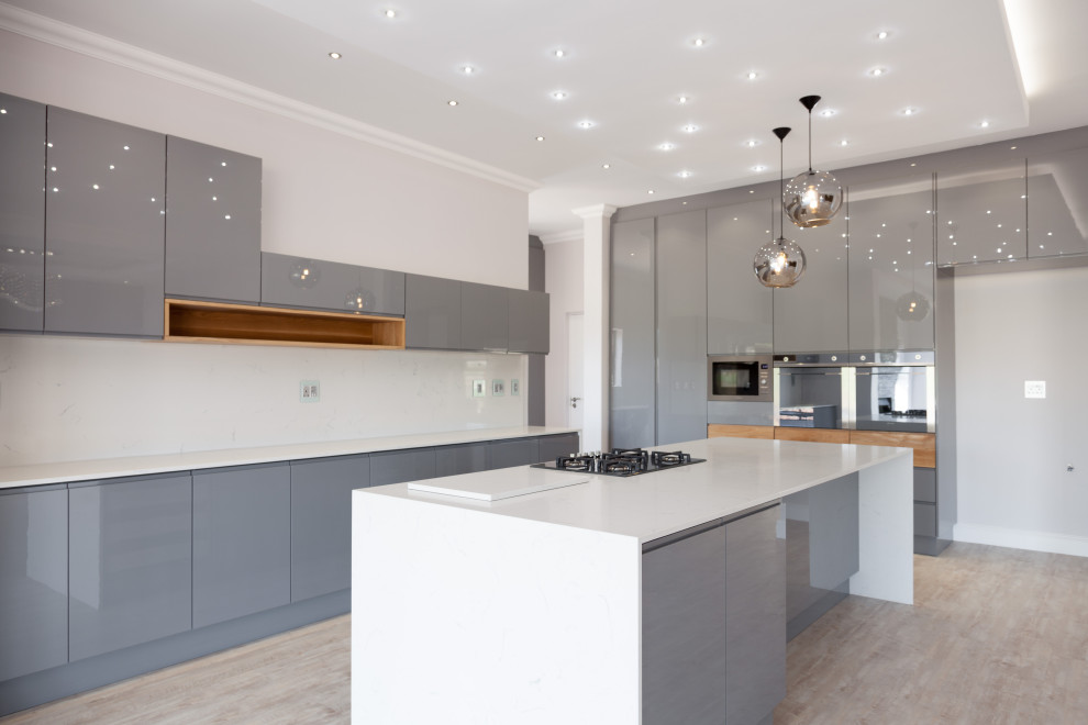 Inspiration for a large single-wall vinyl floor kitchen remodel with gray cabinets, quartz countertops, an island and white countertops