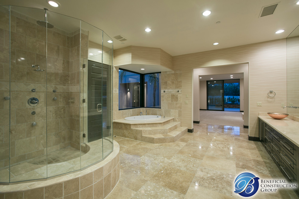 Photo of a large contemporary master bathroom in Los Angeles with a vessel sink, flat-panel cabinets, black cabinets, a corner tub, an open shower, a one-piece toilet, beige tile, stone slab, beige walls and travertine floors.