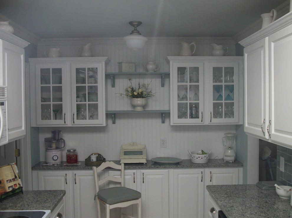 Design ideas for a mid-sized country galley separate kitchen in Detroit with a farmhouse sink, raised-panel cabinets, white cabinets, granite benchtops, blue splashback, subway tile splashback, ceramic floors, no island and beige floor.