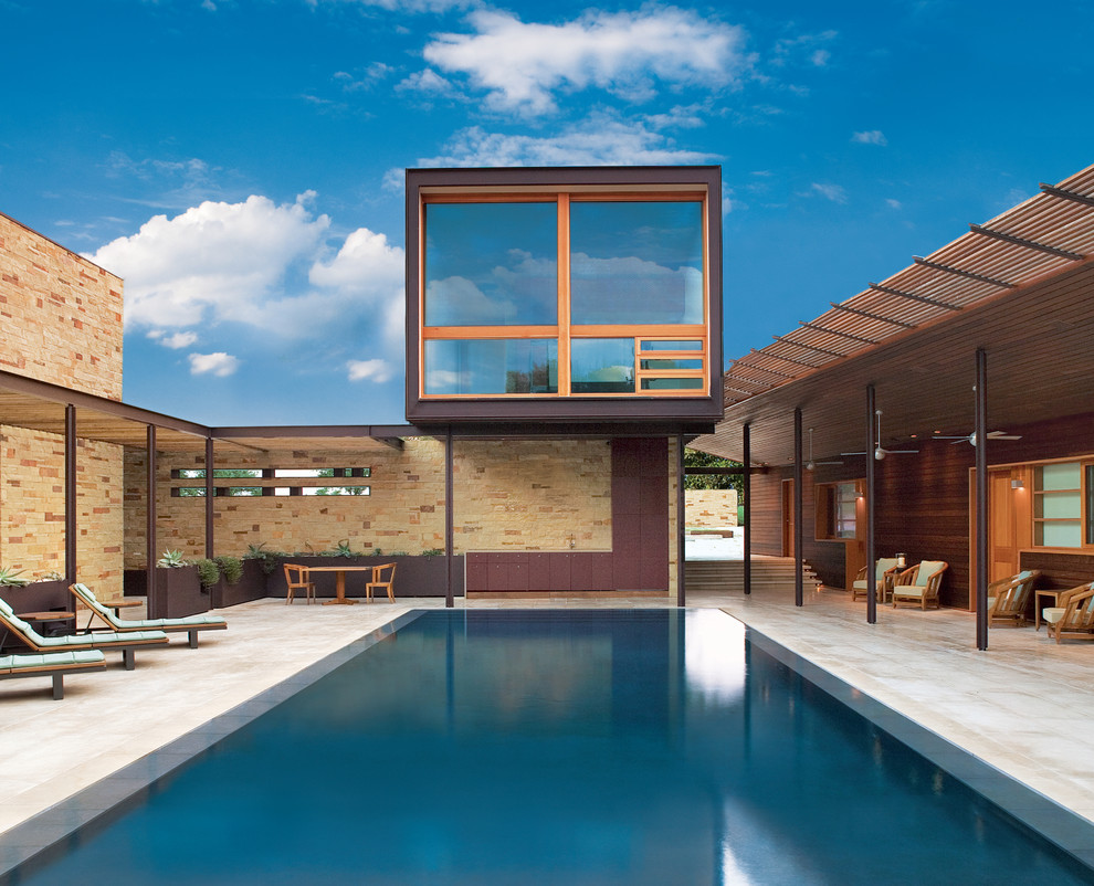 This is an example of a contemporary courtyard rectangular pool in Austin.