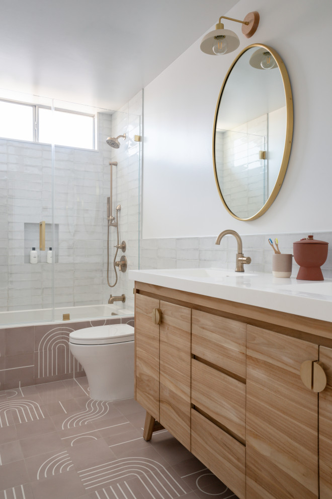 Inspiration for a midcentury bathroom in Los Angeles with flat-panel cabinets, light wood cabinets, an alcove tub, a shower/bathtub combo, white tile, white walls, an undermount sink, brown floor, a hinged shower door, white benchtops, a double vanity and a freestanding vanity.