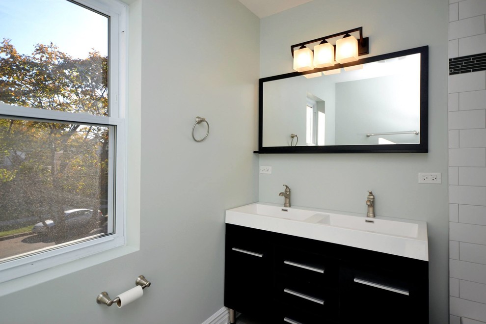 This is an example of a mid-sized contemporary bathroom in Chicago with shaker cabinets, black cabinets, a drop-in tub, a shower/bathtub combo, ceramic tile, white walls, ceramic floors, a drop-in sink and turquoise floor.