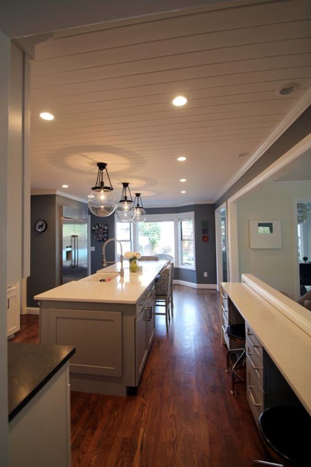 Example of a large transitional u-shaped dark wood floor eat-in kitchen design in Denver with a farmhouse sink, shaker cabinets, gray cabinets, quartzite countertops, white backsplash, ceramic backsplash, stainless steel appliances and an island