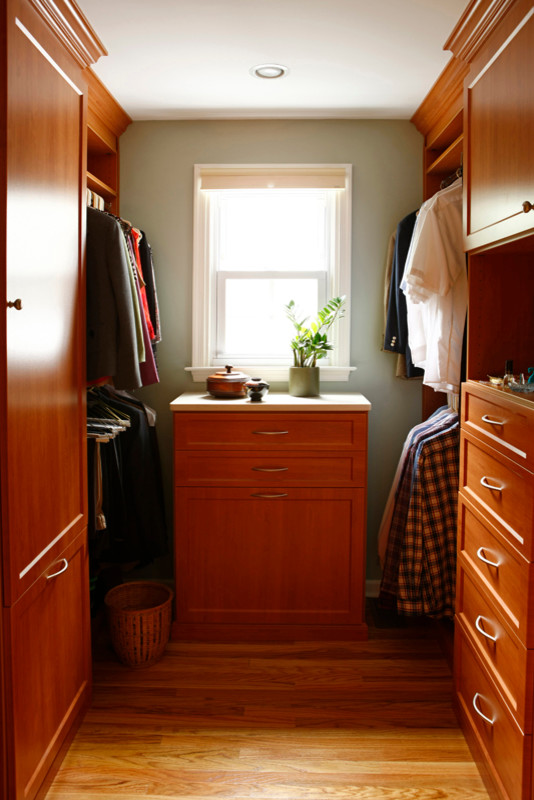 Photo of a mid-sized contemporary storage and wardrobe in Philadelphia with shaker cabinets and light hardwood floors.