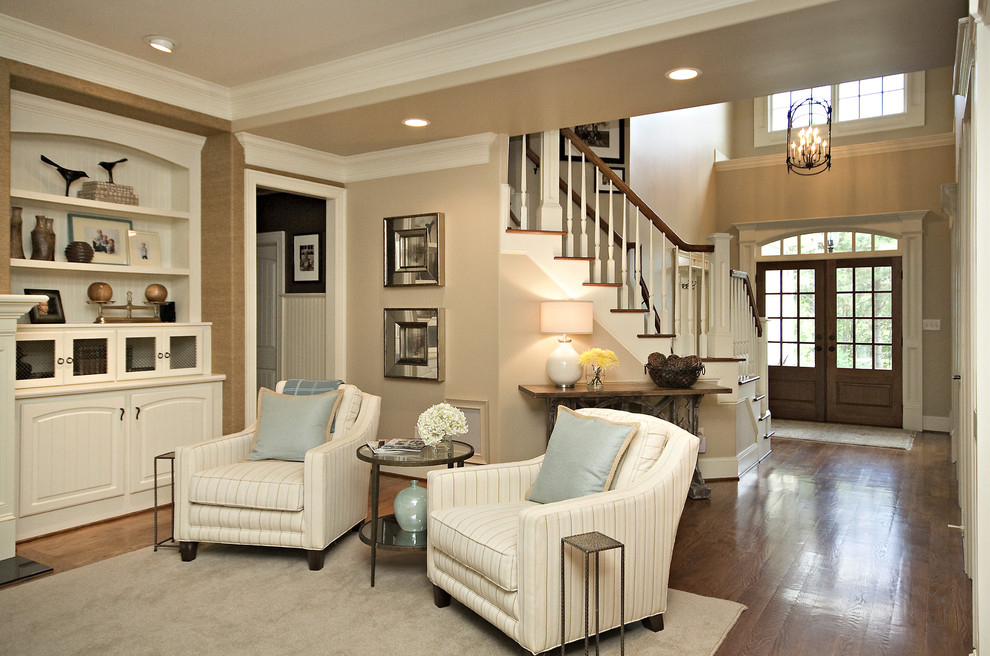 Design ideas for a traditional family room in Raleigh with beige walls and dark hardwood floors.