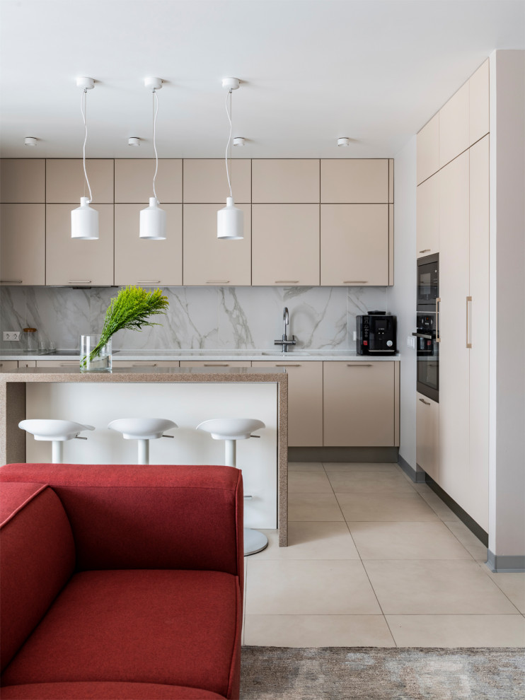 Design ideas for a mid-sized contemporary u-shaped eat-in kitchen in Other with an integrated sink, flat-panel cabinets, beige cabinets, solid surface benchtops, beige splashback, marble splashback, porcelain floors, with island and beige floor.