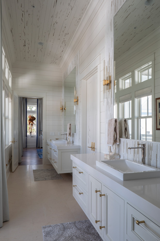 Example of a large beach style master white tile and mosaic tile ceramic tile, beige floor, double-sink, wood ceiling and shiplap wall bathroom design in Other with recessed-panel cabinets, white cabinets, a one-piece toilet, white walls, a drop-in sink, white countertops and a floating vanity